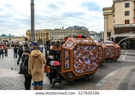 Moscow, Russia - October 14, 2015: Moscow Kremlin and Red Square. The entrance on Red Square has a brisk trade in souvenirs - fur and military caps, wooden nested dolls.