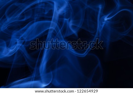 Real blue smoke over black background.