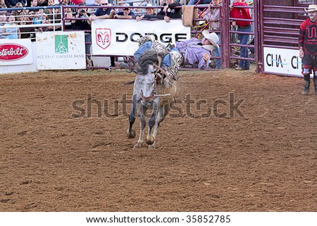 DENTON,TX - AUGUST 22 : Competitor rides a bucking horse at Denton Fairgrounds during North Texas State Fair August 22, 2009 in Denton, Texas.