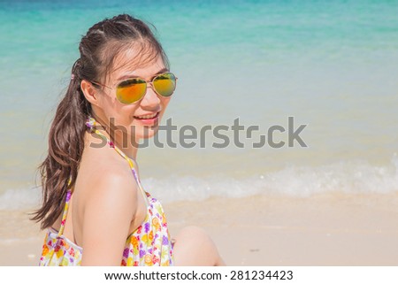 Young women in bikini enjoying on tropical beach.