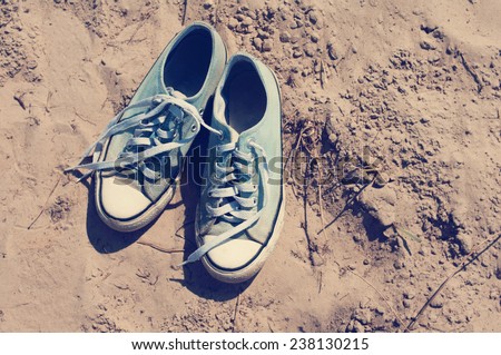 Blue sports gym shoes on sand