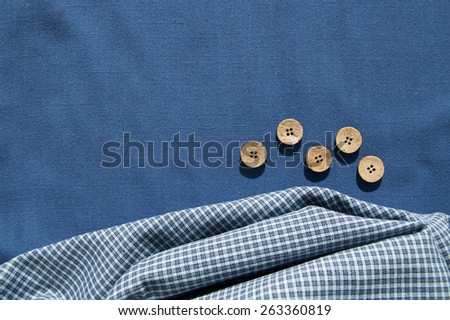 Structure of cotton fabric on a blue fabric background, a fabric background with folds and bends
