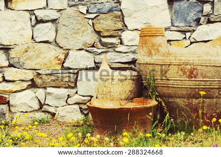 Greek broken clay vases against a stone laying