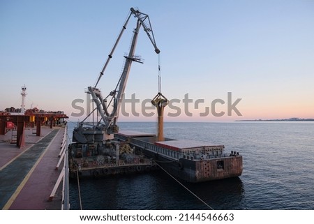 Transshipment of grain products from bulk carrier to the barge on Odessa, Ukraine anchorage during sunset Imagine de stoc © 