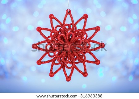 Red Christmas star on bright holiday background. Merry Christmas and New Year card. Winter holidays