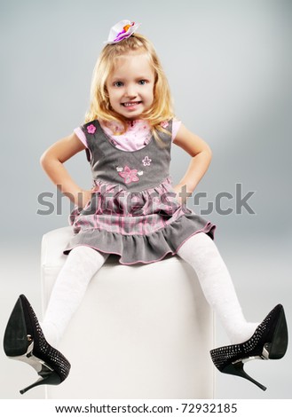 little girl wore high heels and showing off