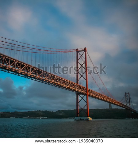 Similar – Foto Bild Die berühmte Brücke Ponte 25 de Abril in Lissabon, Portugal, im Hintergrund einer ruhigen Straße