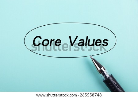 Core values text is on blue paper with black ball-point pen aside.