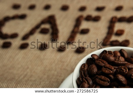 A cup of coffee beans with the word \