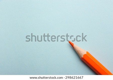 Color pencil is lying on the colored background with copy space.