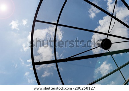 Closeup satellite dishes communication technology network with sky and sun in background