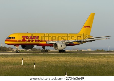 Luqa, Malta April 28, 2015: DHL (European Air Transport - EAT) Boeing 757-236(SF) D-ALEE lined up on runway 31 awaiting take off clearance in the evening sun.