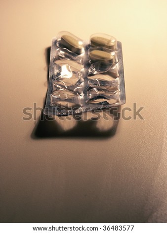 close up shot of pills and its container