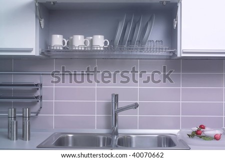 close up shot of open cabinet with plates and cups