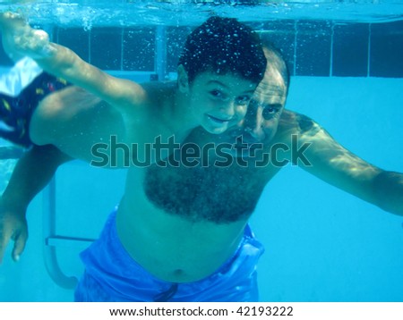 an underwater image of a man and a boy