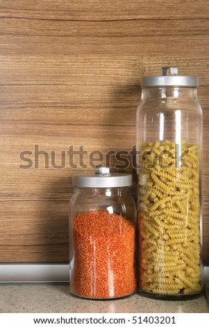 close up shot of pasta and lentil in jars