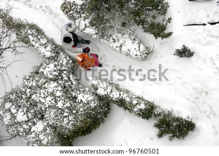 elevated view of people walking on snow covered yard