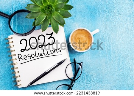 New year resolutions 2023 on desk. 2023 resolutions list with notebook, coffee cup on table. Goals, resolutions, plan, action, checklist concept. New Year 2023 background, copy space Foto d'archivio © 