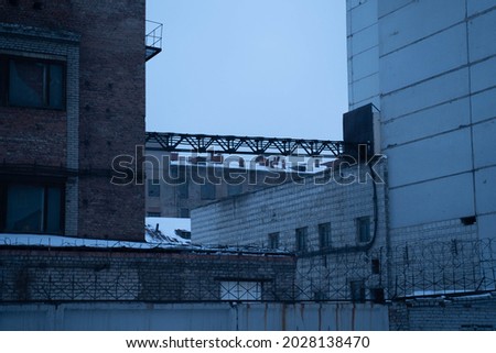 Gloomy urban cityscape. Gloomy factory buildings. Gray, gloomy plant. Old factory buildings. Depressive looking plant. Old factory building. Depression and hopelessness. Heavy photo.
