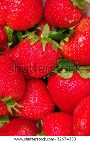 edge-to-edge shot of bright red strawberry fruit. Shallow depth of field.