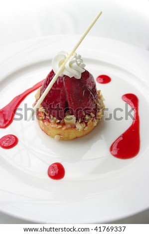 A delicious bite sized Strawberry Tart. On a plate and ready to eat