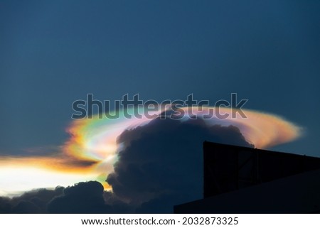 Beautiful iridescent cloud, Irisation. Skyscraper background. Photo stock © 
