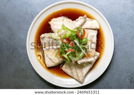 Similar – Foto Bild Zubereitung von Bass-Fischfilets in mediterraner Sauce mit Tomaten, Oliven und Kapern in einer Backform auf rustikalem Holzgrund mit Zutaten. Ansicht von oben