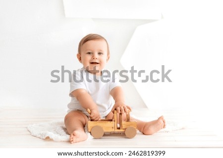 Similar – Image, Stock Photo 6 month old baby playing wearing black and white playing with colorful ring stack toy