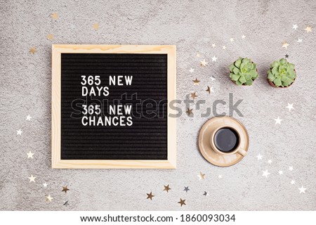 365 new days, 365 new chances. Letter board with motivational quote on grey concrete background with coffee cup. New year resolutions and goal setting, self improvement and development concept.  Foto d'archivio © 