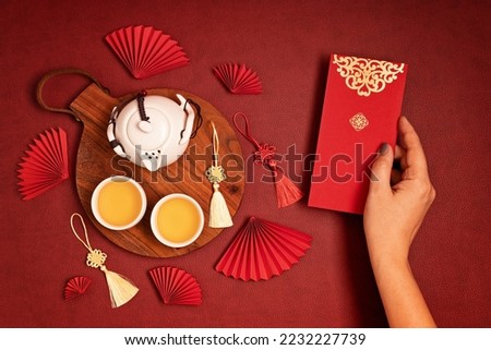 Similar – Image, Stock Photo Hand holding red cup with steaming drink against the light