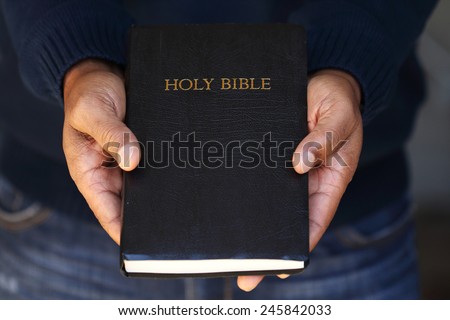 Man holding a Bible in his hand.
