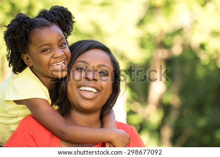 Happy African American mother and daughters.