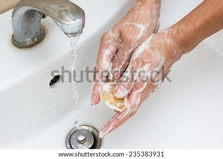 cleaning : Washing hands with soap under running water