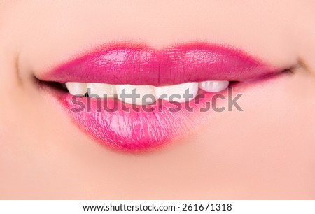 The girl bites her lips with passion