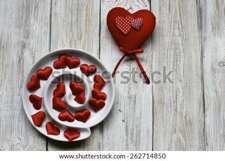 Spiral red hearts on white wood