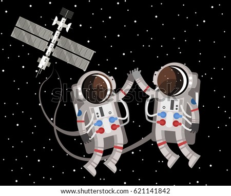 two astronauts floating around space station