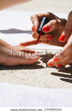Friends painting her nails