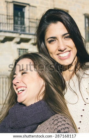 Two female friends laughing