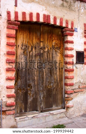 old wooden door framed with bricks
