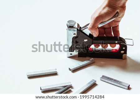 Furniture construction stapler next to staples on a white background. Photo stock © 