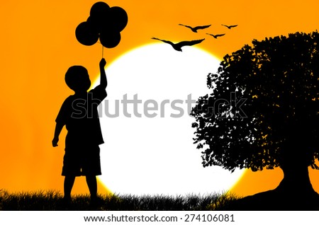 Silhouette of the boy standing and holding bubble on sunset looking  the eagle bird fly on yellow sky