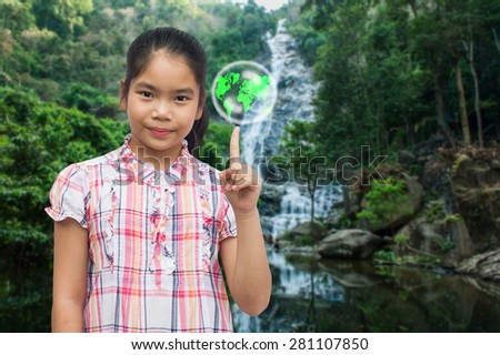 environment concept,save the world,cute asian girl  standing point finger on  the map world wild cascade natural  background