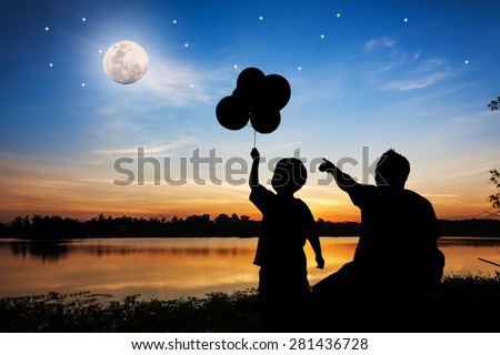 father use hand point the full moon and the star on the sky his son see at the river