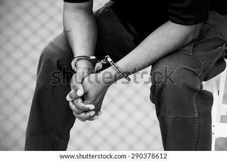 black and white of the man was bound by hand in the handcuffed out of freedom