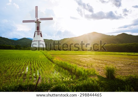 the wind turbine in The morning  green rice field,renewable concept save the world