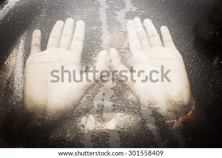hand girl behind water drop on glass in the car ,vintage tone