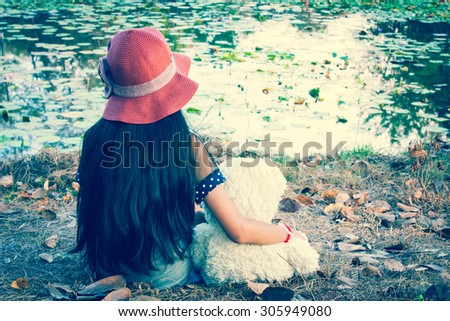 vintage tone,asian girl sad sitting alone in the park