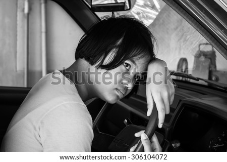 asian girl sad alone sitting  in the old car,vintage tone