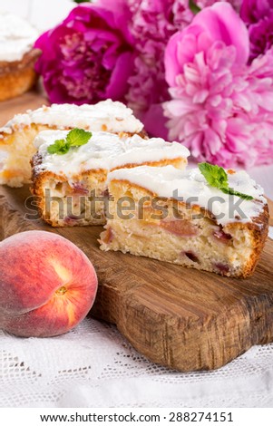Three pieces of peach cake on a wooden board