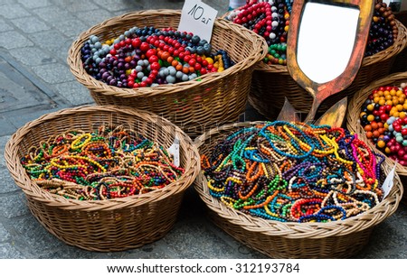 The baskets with colorful wooden beads on the street market.